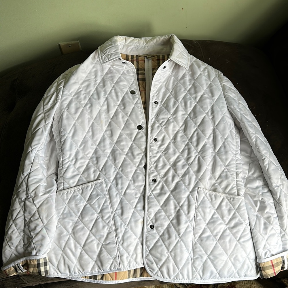 White Burberry jacket slightly used. Has some discolorations on the neck
